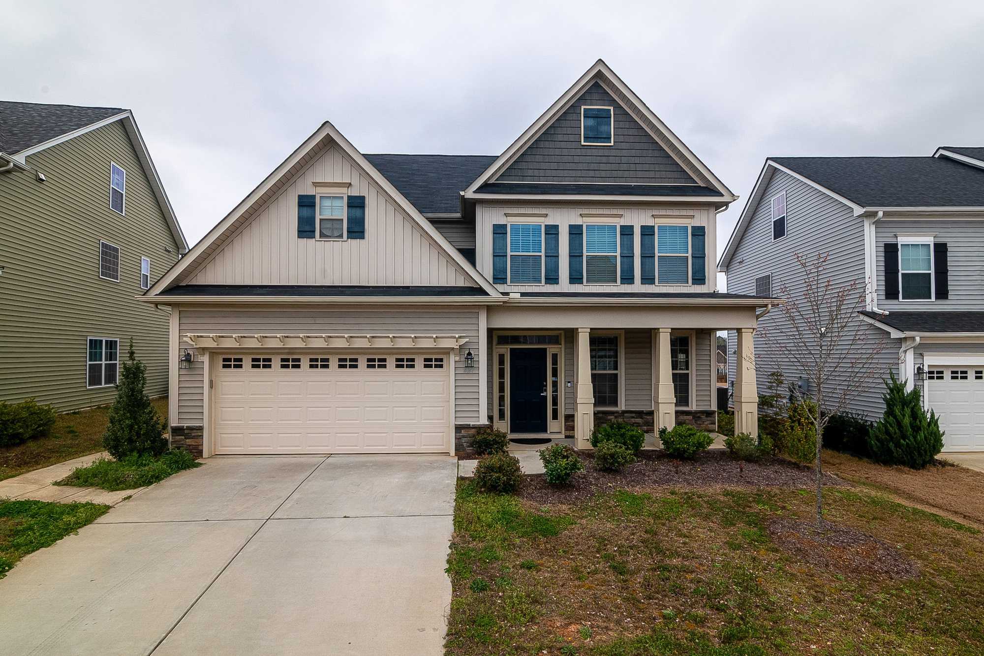 Two-story craftsman-style home with a double raised-panel garage door